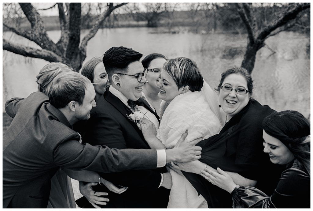 friends and family surround newlyweds by Austin wedding photographer
