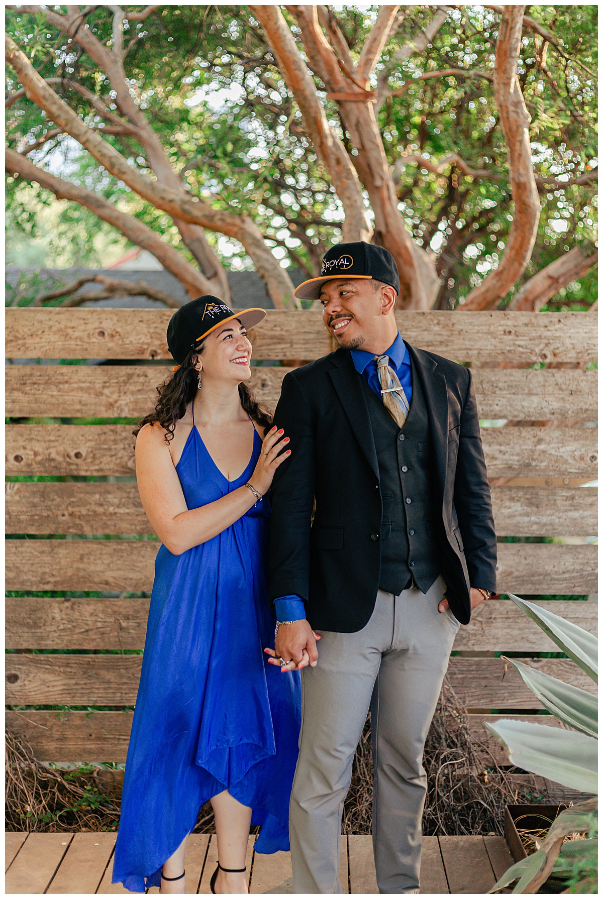 couple wearing hats looks at each other for South Congress couple's shoot