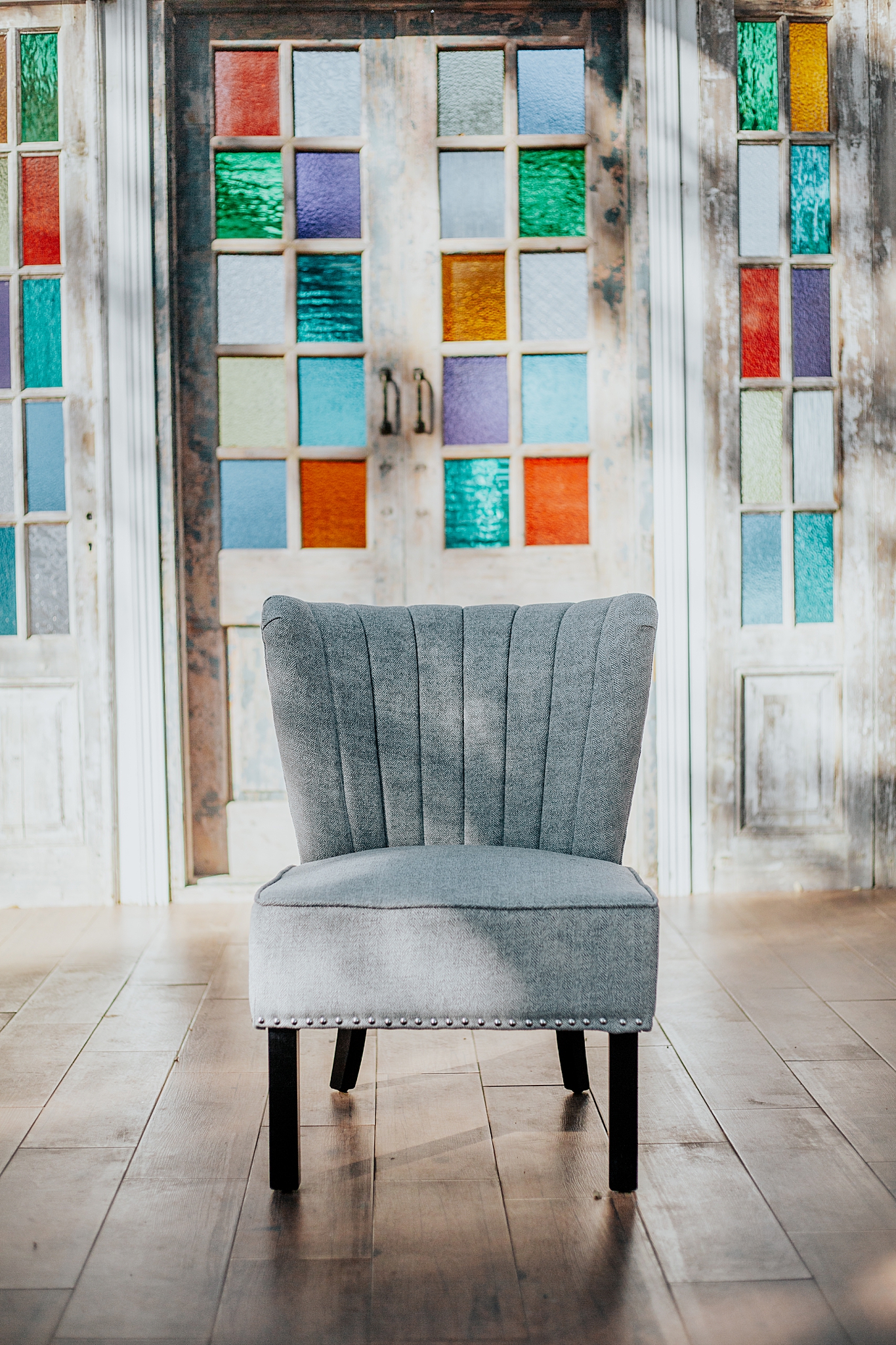 gray chair sits in front of wall of doors by Austin photographer