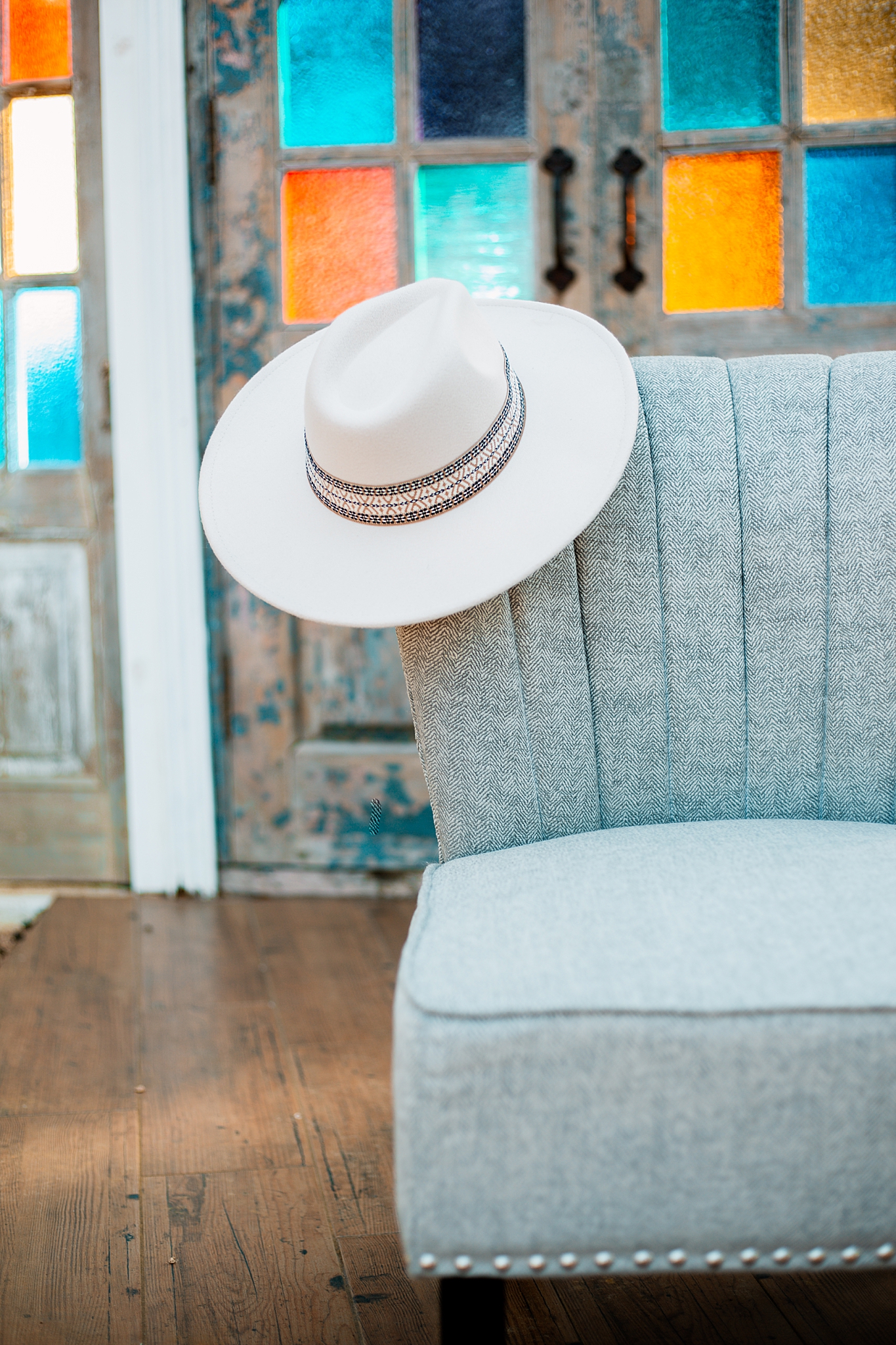 cowboy hat hangs on chair by Ellie Chavez Photography