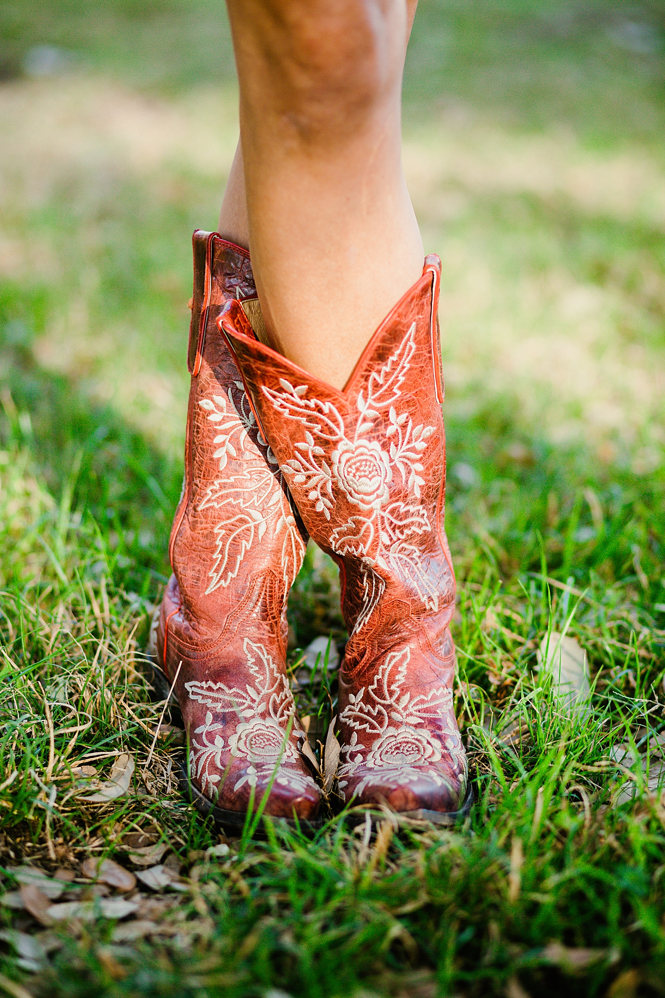 legs are crossed wearing brown detailed cowboy boots by Austin photographer