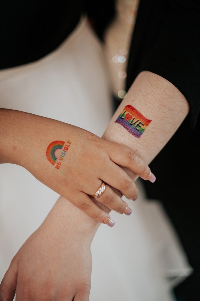 lovers show off temporary pride tattoos on their arm and hand by Ellie Chavez Photography 