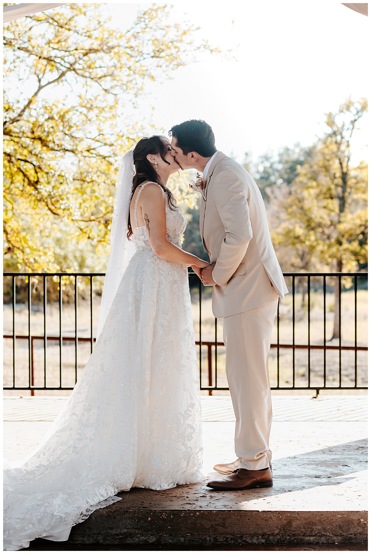 Bride and groom kiss at Texas ranch ceremony