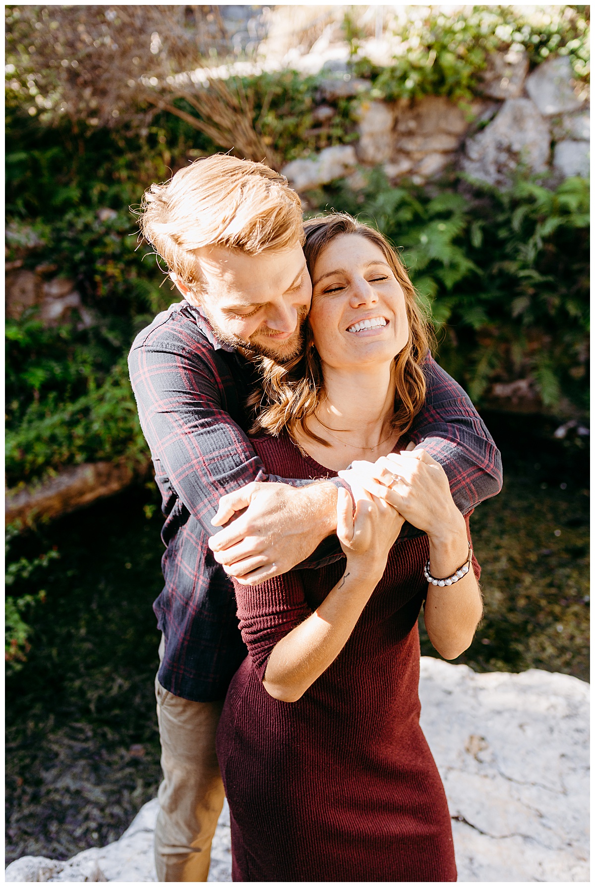 Man hugs woman from behind by Austin wedding photographer