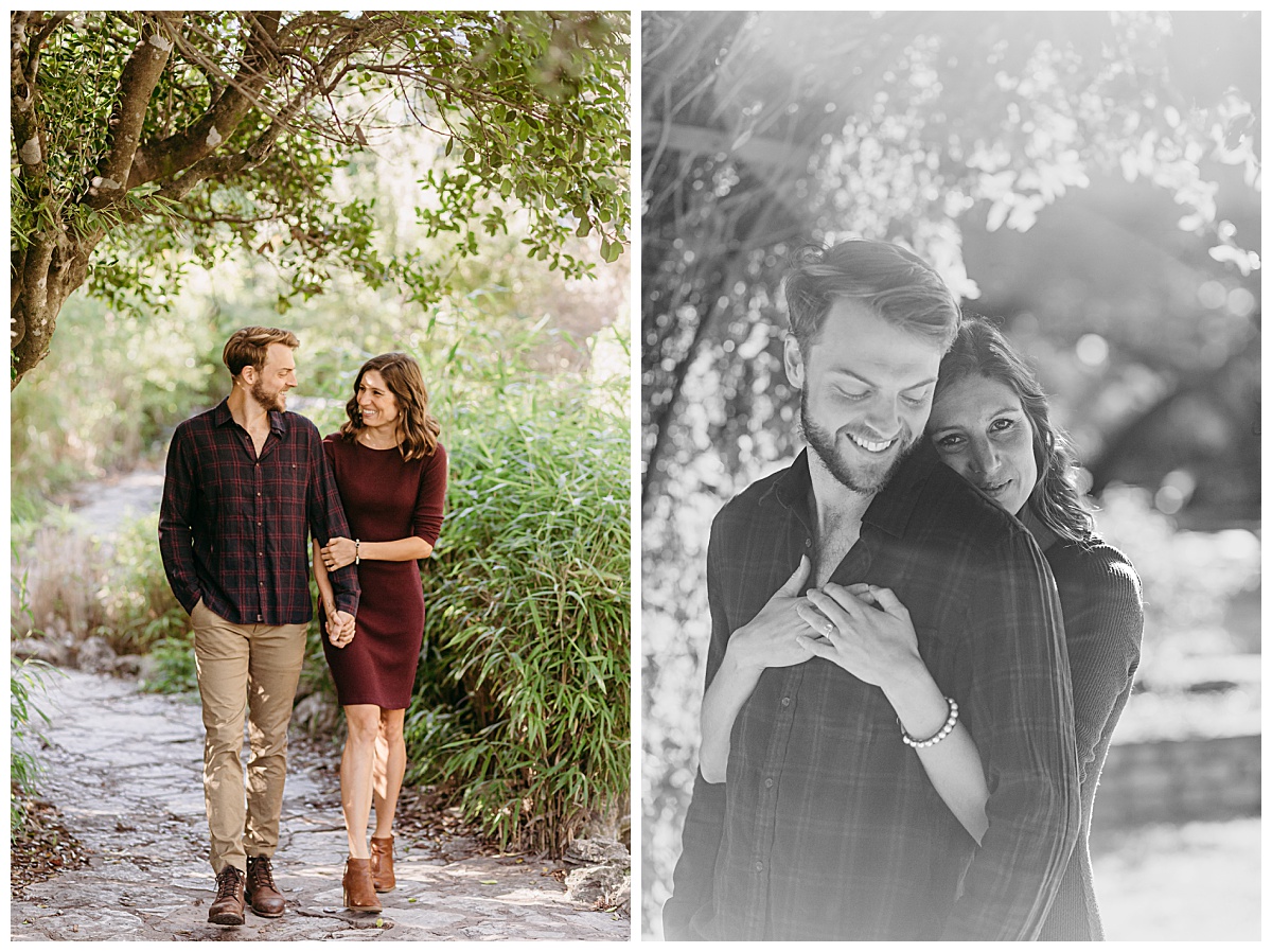 Fiances hold hands and walk down path at garden engagement session