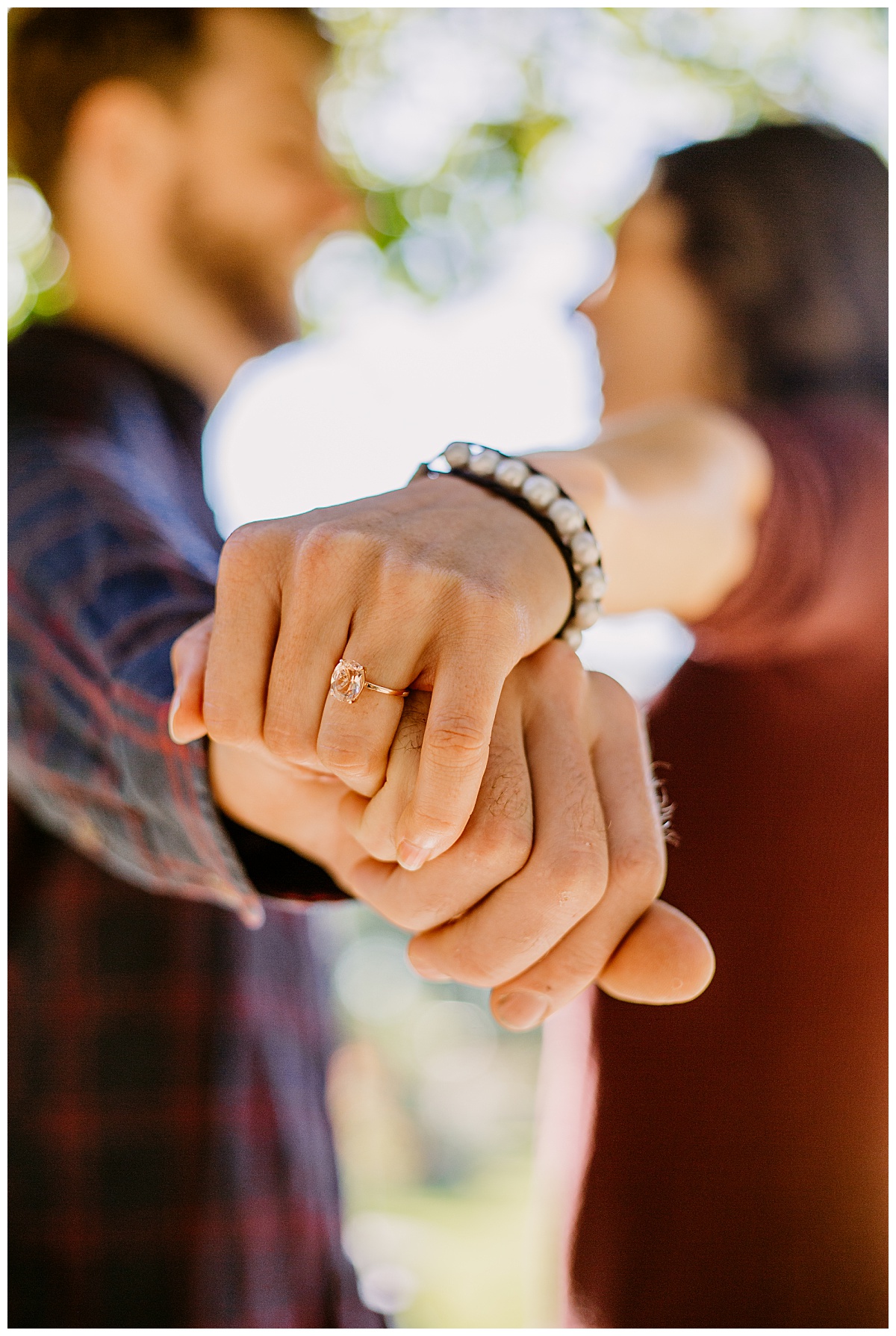 Woman shows off ring at garden engagement session