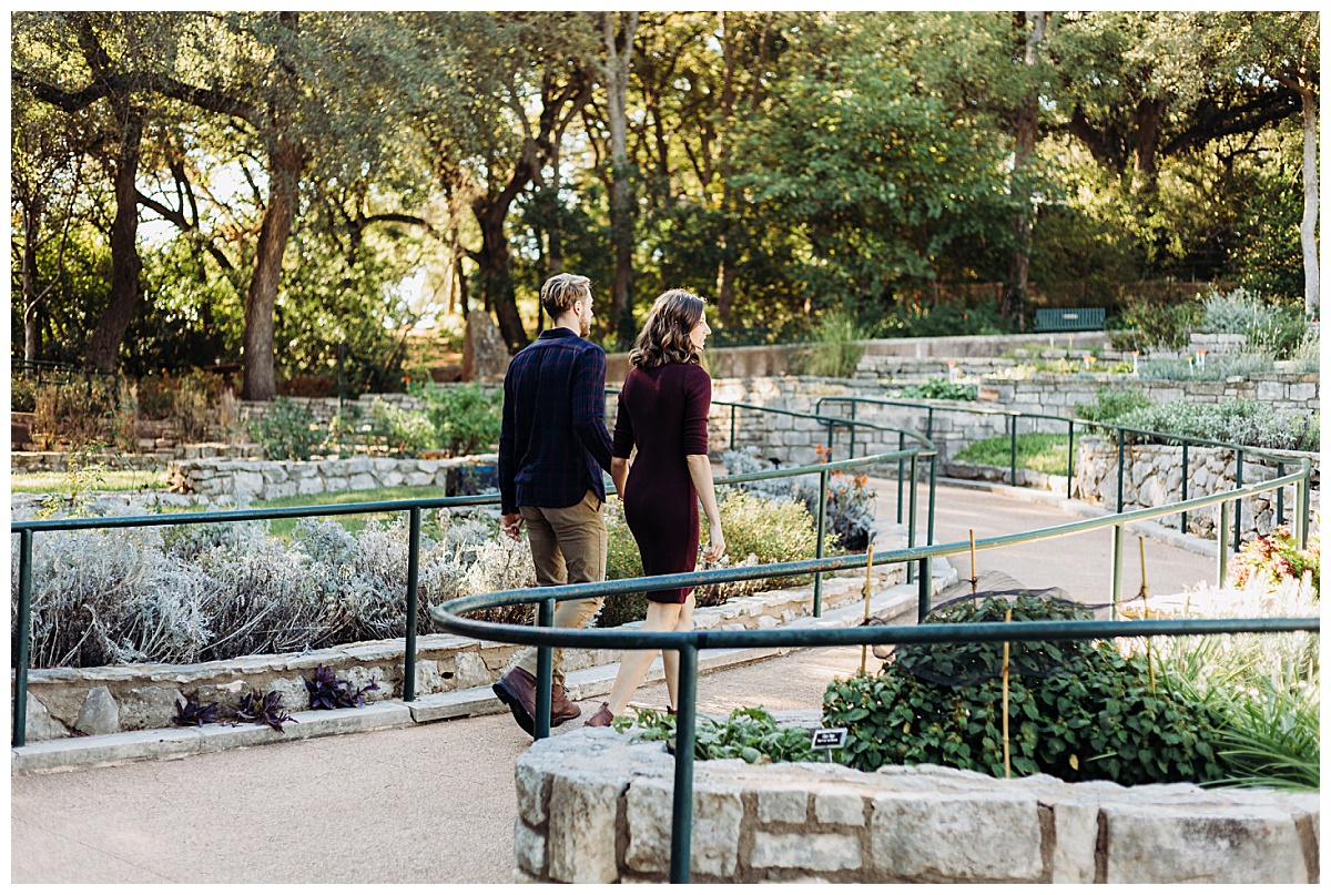 Couple walks through botanicals by Austin wedding photographer
