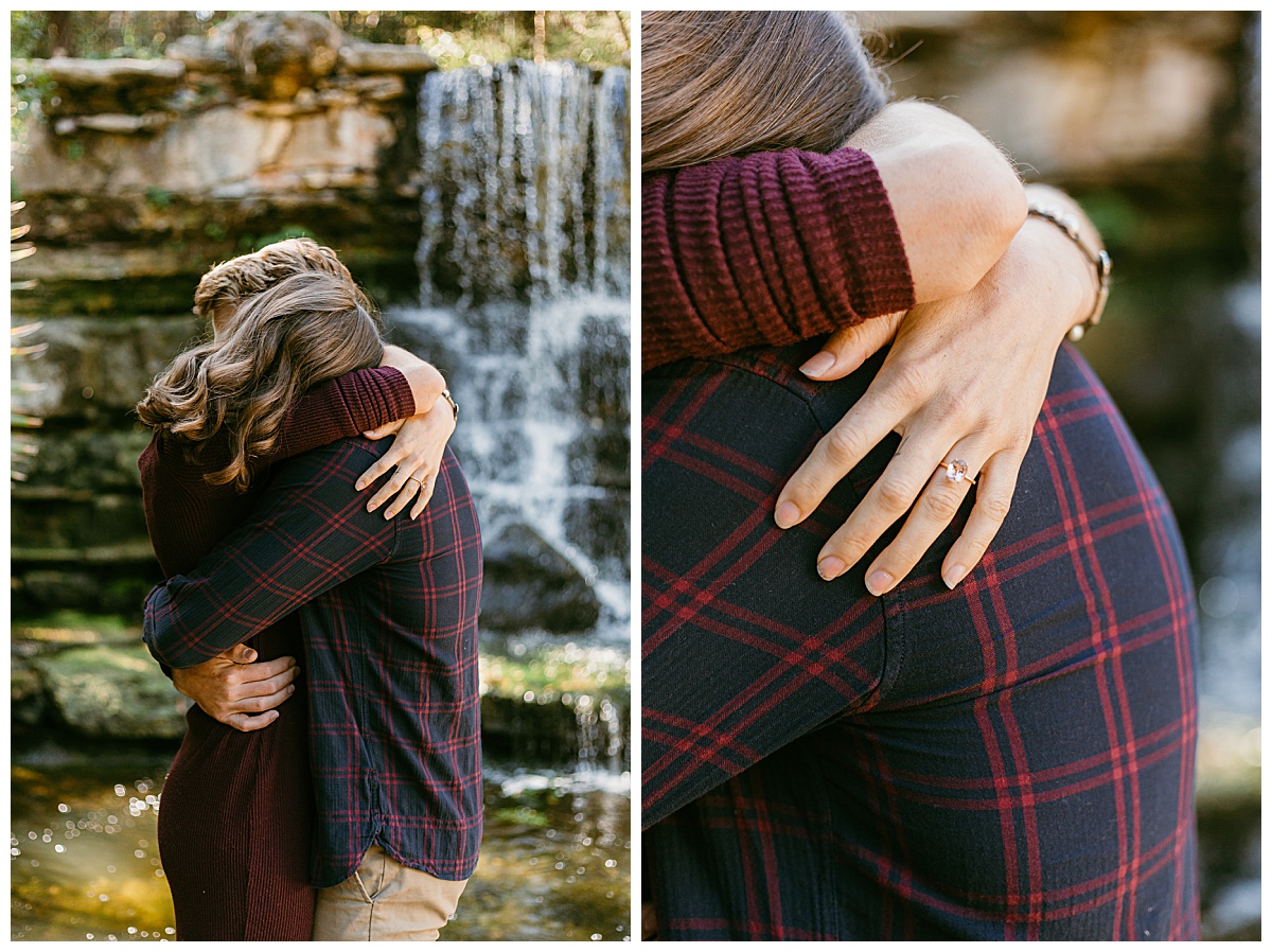Fiances hug in front of waterfall at garden engagement session