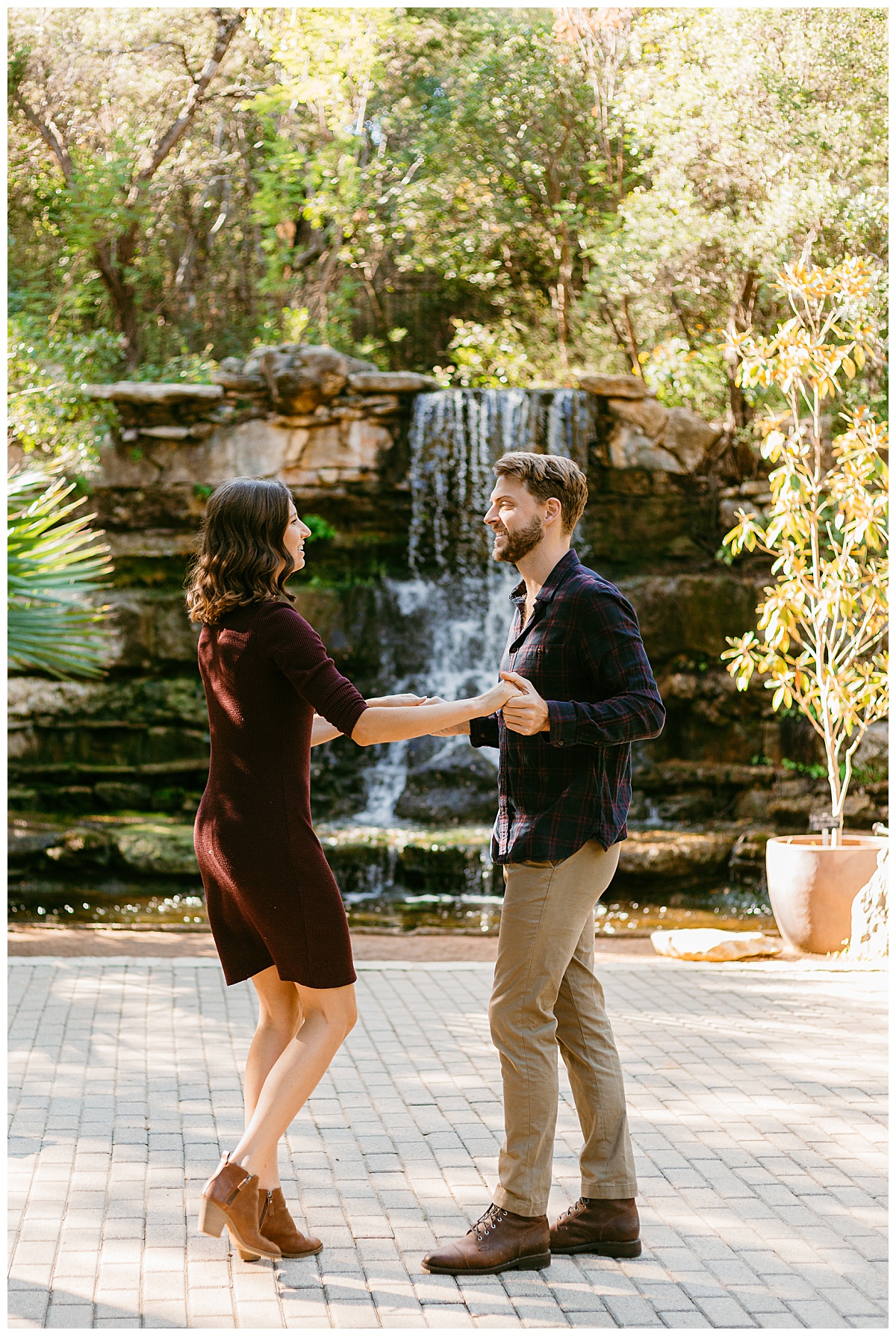 Couple dances together in front of waterfall by Austin wedding photographer