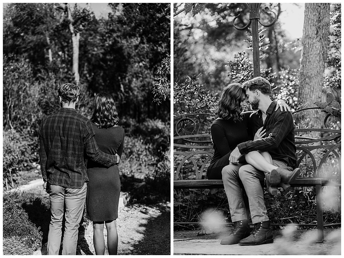 Woman sits in man's lap and stands next to him at garden engagement session