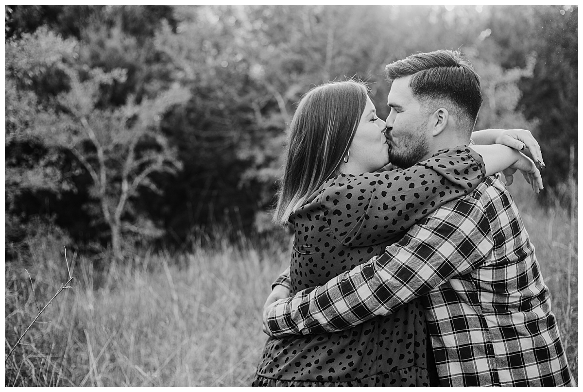 couple kisses with arms around each other by Ellie Chavez Photography
