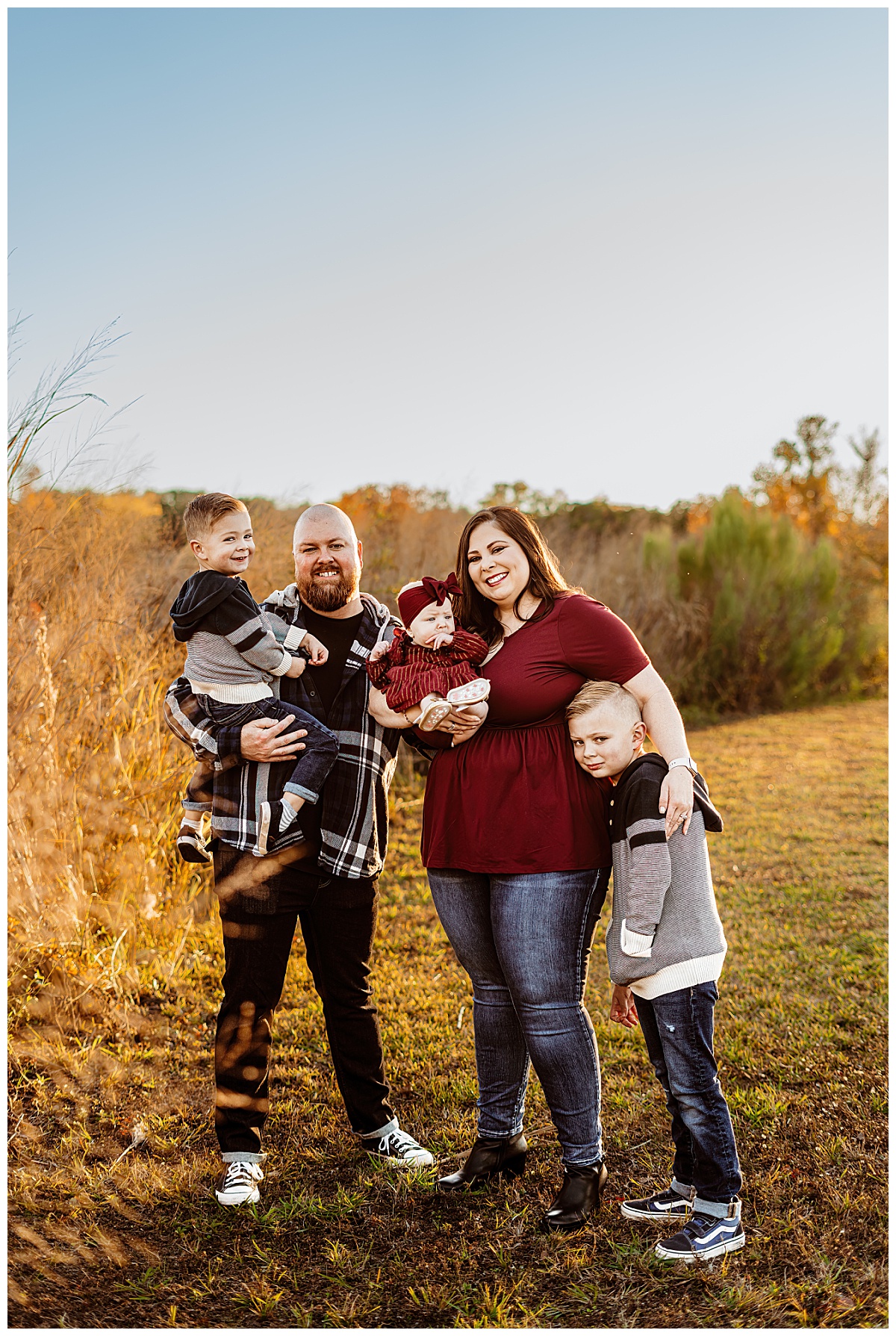 mom holds daughter and son close while dad holds son by Ellie Chavez Photography