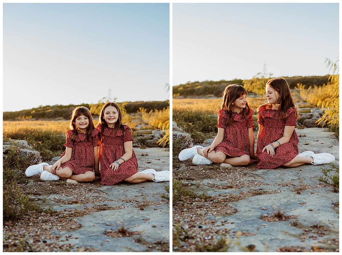 sisters sit together with legs to the side by Ellie Chavez Photography