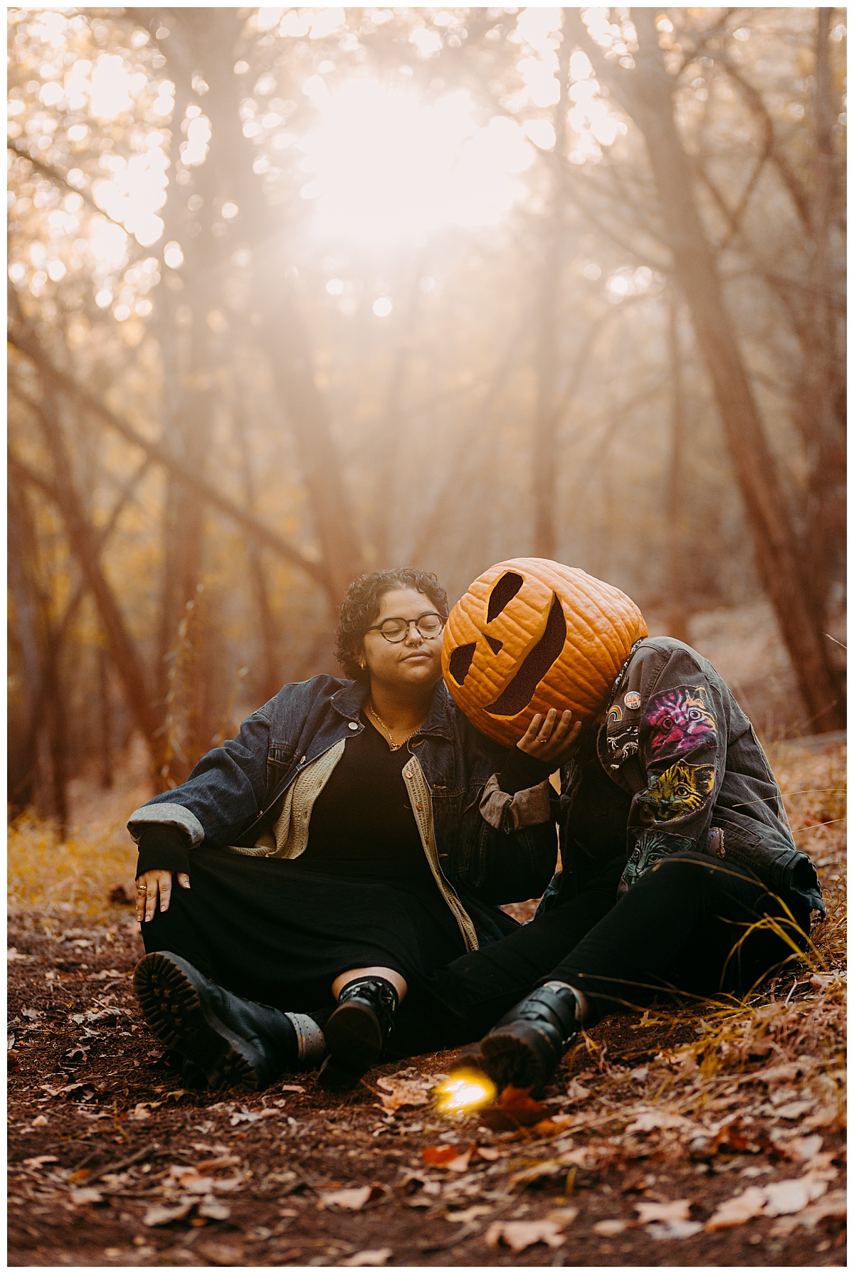pumpkin head leans on partner who holds their chin during early morning couples session