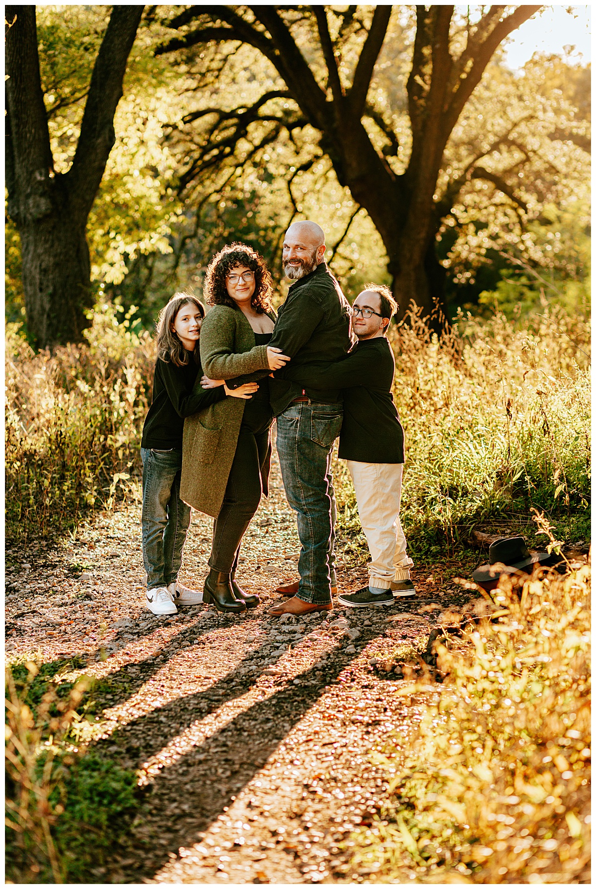 loved ones face each other in wooded park for Ellie Chavez Photography