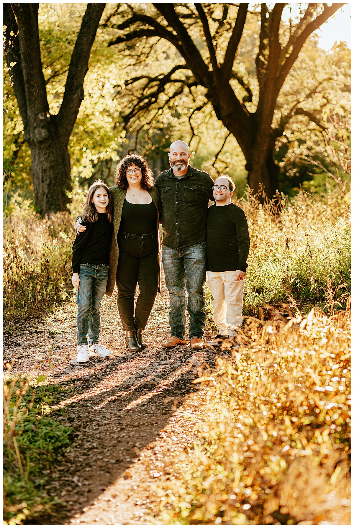 loved ones stand on path during golden hour at Bull Creek Family Session