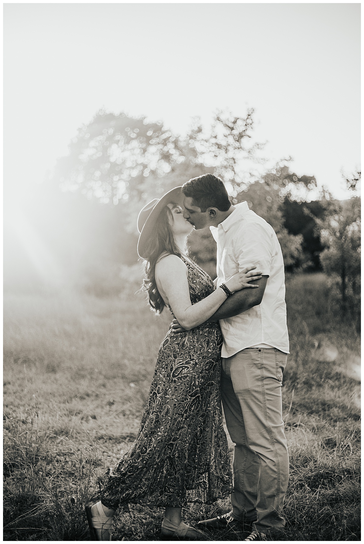 fiances kiss with light shining on them by Austin wedding photographer